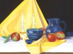 Apples sitting on a yellow cloth with blue pitcher and blue bowl